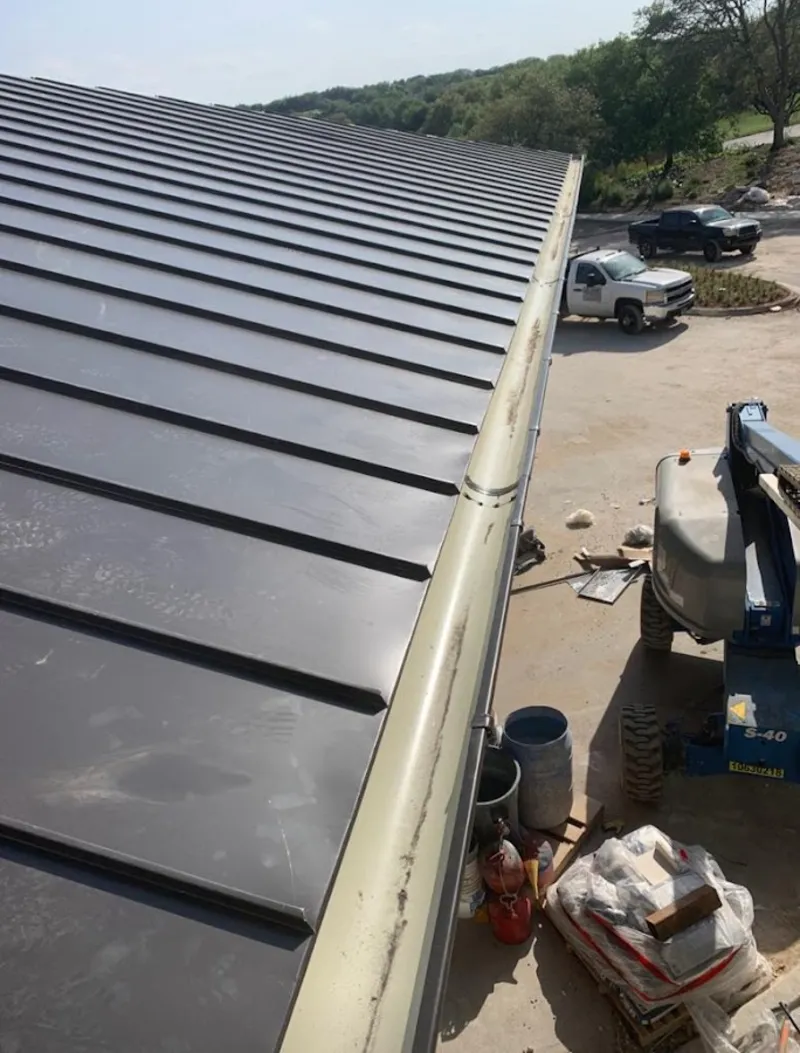 Standing seam panel and gutter detail on a metal roofing jobsite in Scappoose